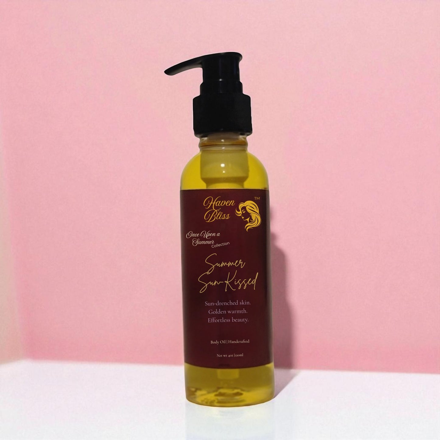 Haven Bliss Skincare Summer Sun-Kissed Radiant Body Oil, a golden-hued oil in a clear pump bottle with a maroon label.