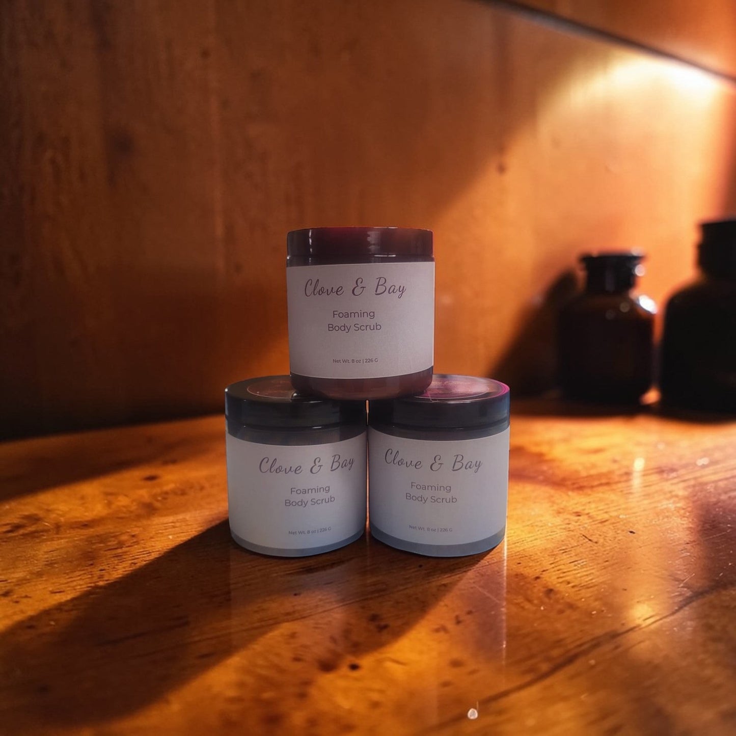 Haven Bliss Skincare Clove & Bay Foaming Body Scrub in an 8oz jar, creamy texture with spice infusion.